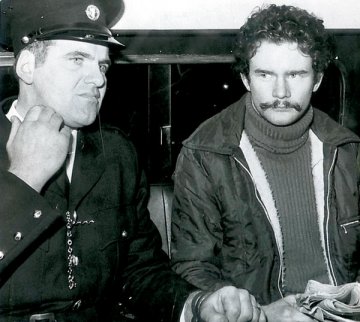 Wearing a moustache, Martin McGuinness in Garda custody prior to one of his court appearances in Dublin