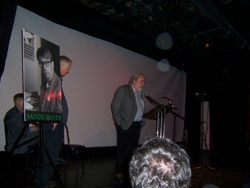 Mike Fleshman address the memorial ceremony at Theatre 80