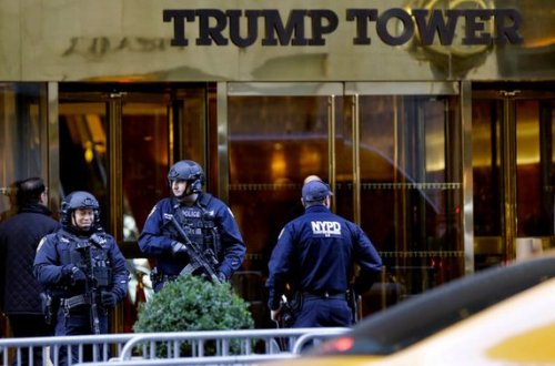 Heavily armed New York cops stand guard outside Trump Tower in Manhattan. The new president